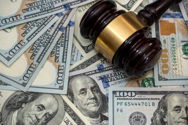 istock Wooden gavel on american dollars bills 1297429907