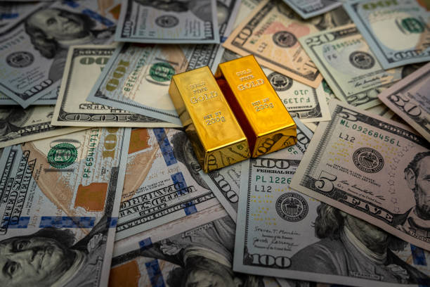 Gold bars on 100 US Dollar note as background Gold bars on 100 US Dollar note as background. financial concept best gold ira us stock pictures, royalty-free photos & images