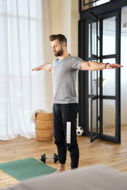 istock Athletic young man doing morning gymnastics at home 1297430114
