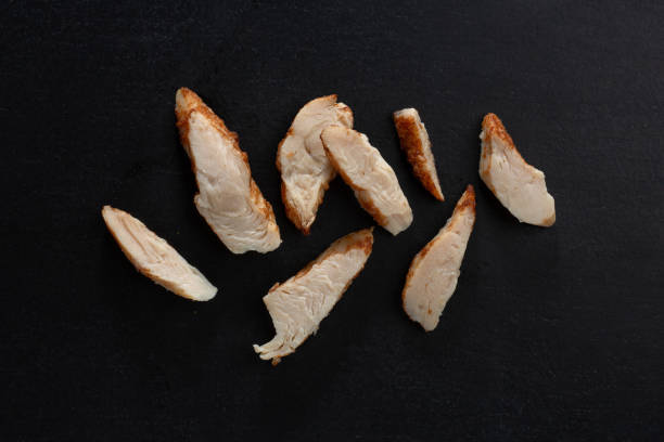 closeup of chicken breast chunks on dark - chicken breast chicken grilled chicken protein imagens e fotografias de stock