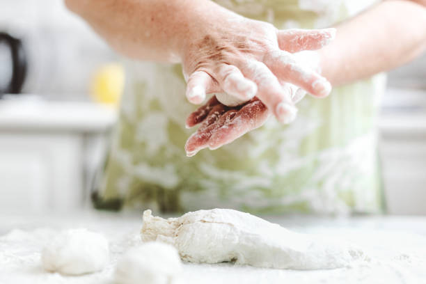 istock Woman kneading dough at home kitchen 1297431445