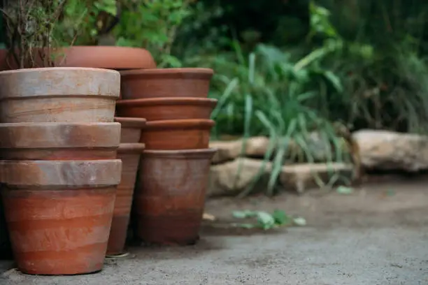 Used old empty terracotta/clay flower pots in the garden, close up.