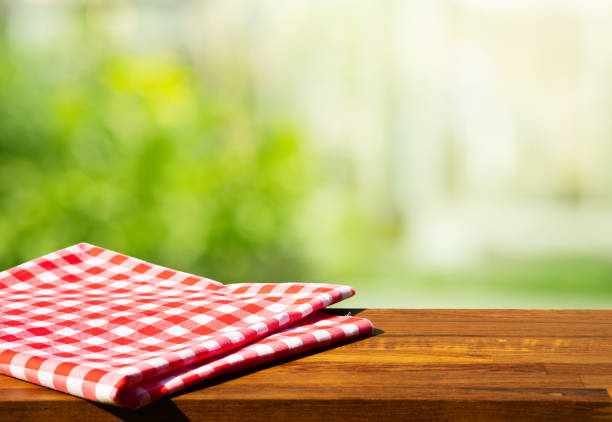 istock Cloth napkin on wood table with glass window background 1297433300