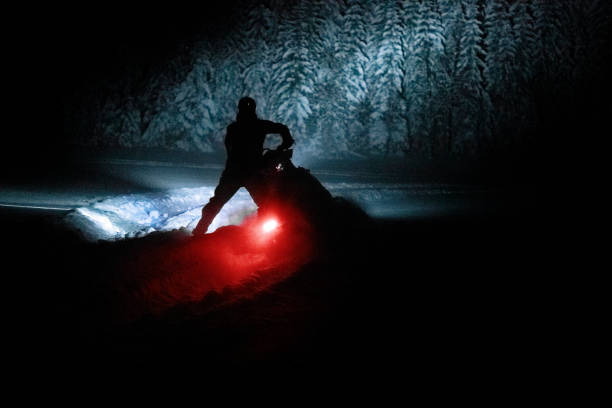 Snowmobiling in the dark Silhouette of search and rescue snowmobile in the dark Snowmobiling stock pictures, royalty-free photos & images