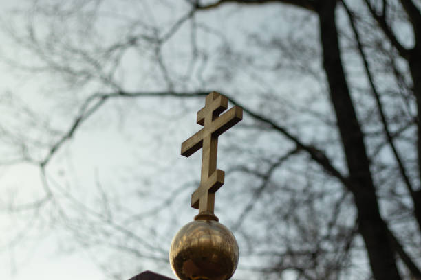 istock Orthodox cross on a gloomy sky background. Religion concept, faith problem 1297433340