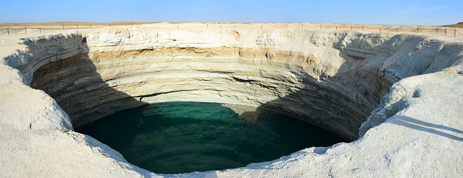 Karakum Desert north of Darvaza, Dashoguz Province, Turkmenistan: looking down the Turquoise crater - a water filled sinkhole in a natural gas field, the result of a collapsed cavern. Turkmenistan holds the world's 4th largest natural gas reserves.