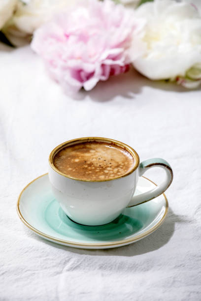 istock Coffee and peonies flowers 1297437725