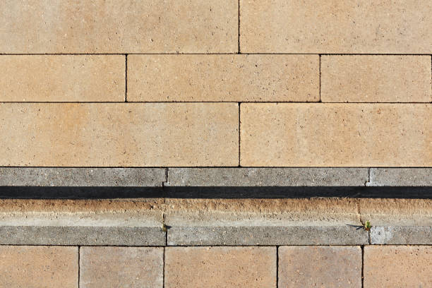istock Concrete drainage gutters are connected on the sidewalk. View from above. 1297437741