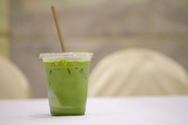 istock Iced green matcha tea in glass with paper straw 1297438009