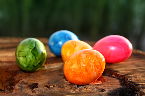 Hand colored colorful easter eggs on orange colored background