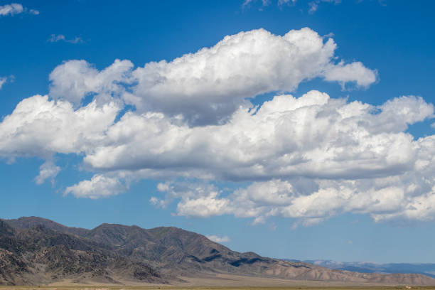 istock Amazing cloudly sky under mountains in south Kazakhstan 1297439268