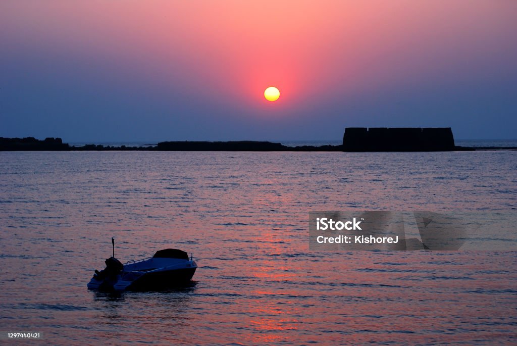 Glorious, colorful sunset behind historical Kolaba Fort, Alibaug, District Raigad, Maharashtra. Glorious, colorful sunset behind historical Kolaba Fort, Alibaug, District Raigad, Maharashtra. Kolaba Fort is situated right in the middle of the Arabian sea. Beach Stock Photo