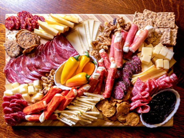 a beautifully arranged delicious, colorful, charcuterie and cheese board - italian appetizer imagens e fotografias de stock