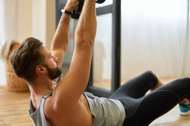 istock Handsome bearded man doing exercise with elastic fitness band 1297443338