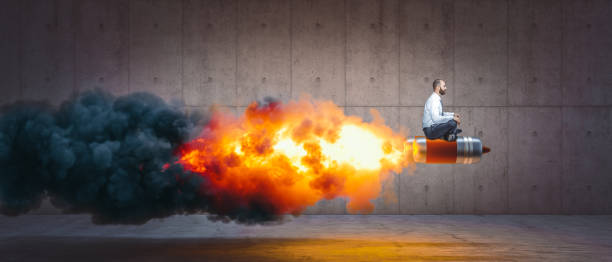 istock man sitting on a rocket with flames and smoke. 1297443928