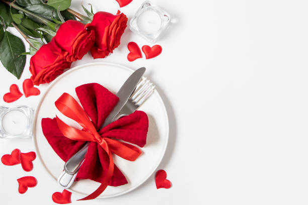 istock Valentine's day romantic dinner concept. Beautiful table setting. Roses and candles on a white background. 1297444613