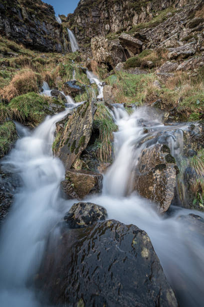 istock A waterfall, cascading down a cliff, with hint of sunrise in the sky 1297444829