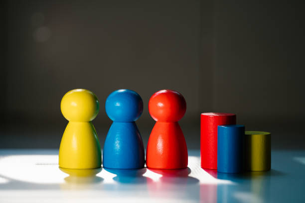 istock The colorful wooden people on sunlight background 1297444850