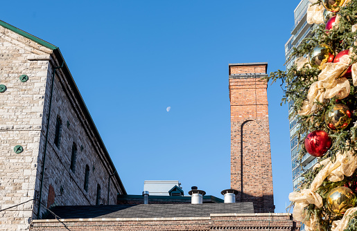Old brick chimney stack with blue sky and moon.
