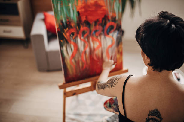 istock Tattooed female painter painting 1297445259