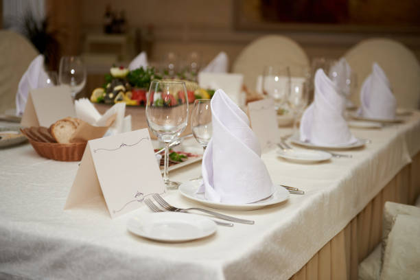 istock Table set with blank guest card, plate with serviette and cutlery on table, copy space. Place setting at wedding reception. Table served for wedding banquet in restaurant 1297445363