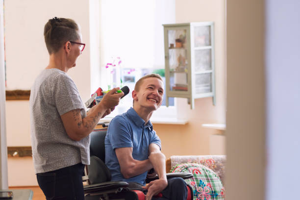 istock Young disabled man helped by his mom 1297446879
