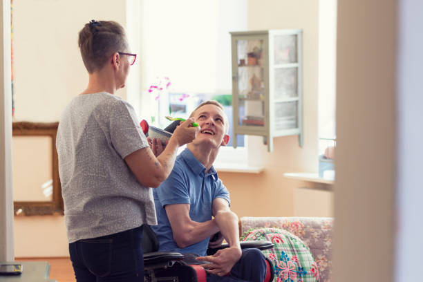 istock ALS patient fed by mother 1297447040