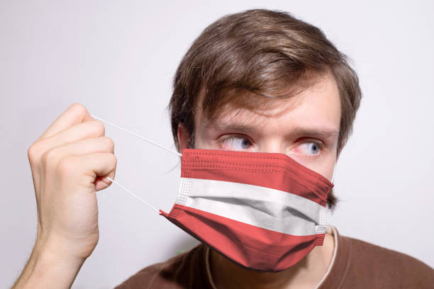 istock Young Austrian man wearing Austria face mask during coronavirus pandemic 1297448624