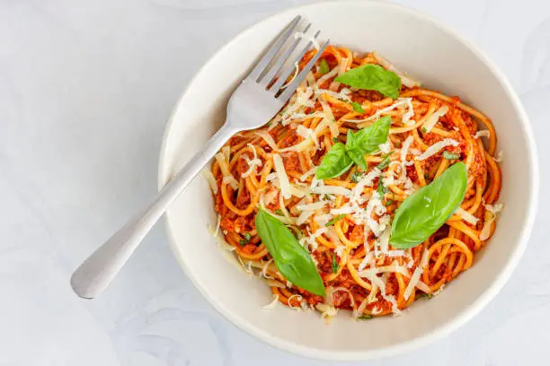 Italian Spaghetti Bolognese in a Bowl on White Background Top View