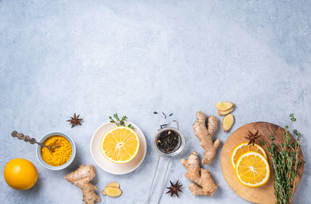 istock Immune boosting remedy. Flat lay  with ingredients for anti-virus drink from turmeric, thyme, lemon and  star anise on blue background 1297449570