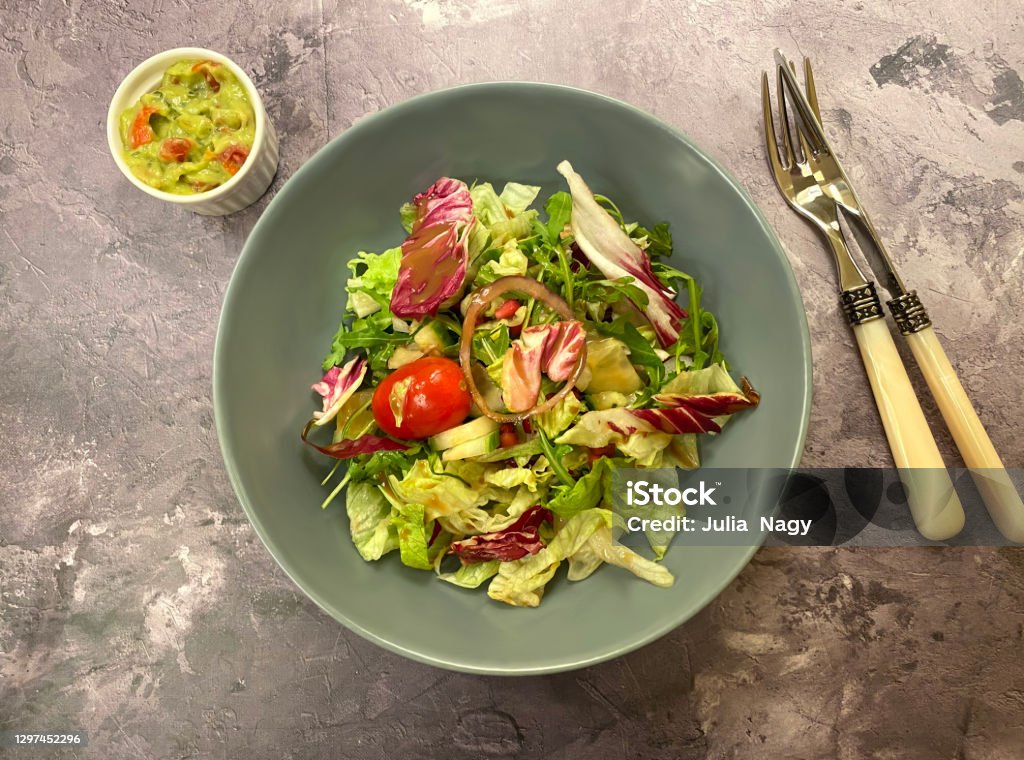 Healthy mixed salad with eisberg, arugula, radicchio, cherry tomato and balsamic dressing. Appetizer Stock Photo