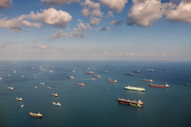 Transportation and Container ships on the ocean, Singapore Singapore: Transportation and Container ships wait on the ocean in front of the port of Singapore. industrial ship stock pictures, royalty-free photos & images