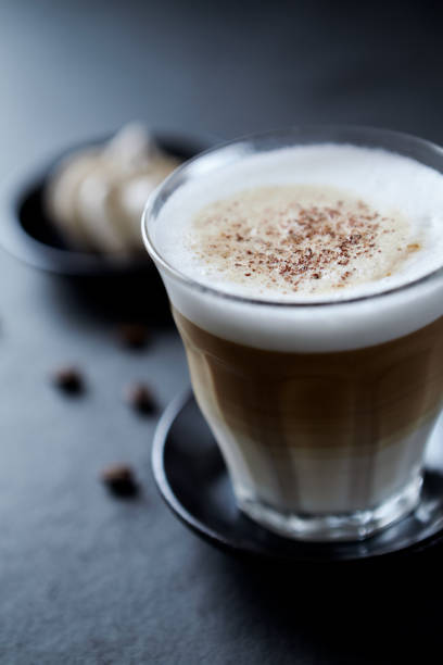 istock Coffee with milk on dark stone background. Close up. 1297454079
