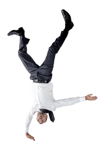 Businessman upside down balancing on one hand. Businessman upside down balancing on one hand. isolated on white. upside down stock pictures, royalty-free photos & images