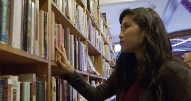 istock Woman Browsing in Bookstore 1297456363