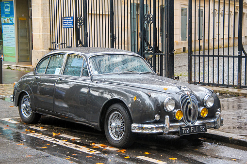 Paris, France - August 8, 2014: Grey vintage car Jaguar Mark 2 in the city street.