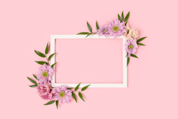 istock Empty flower frame made of eustoma on a pink pastel background. 1297457570