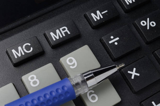 istock a ballpoint pen lies on a calculator. close-up. 1297462327