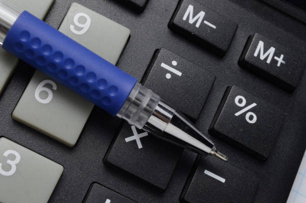 istock a ballpoint pen lies on a calculator. close-up. 1297462584