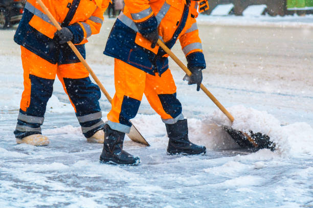 Communal services workers sweep snow from road in winter, Cleaning city streets and roads during snowstorm. Moscow, Russia. Communal services workers sweep snow from road in winter, Cleaning city streets and roads during snowstorm. Moscow, Russia snow plow stock pictures, royalty-free photos & images