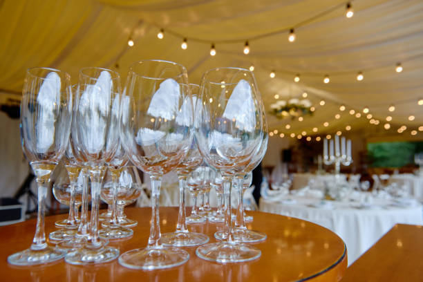 istock Sparkling glassware with wine and champagne on dinner table in restaurant, copy space. Crystal glasses ready for celebration. Wineglasses at luxury wedding reception 1297463406