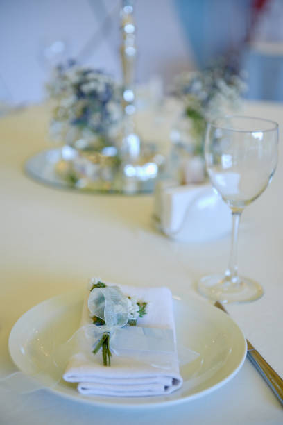 istock Table set with blank guest card, plate with white napkin and cutlery on table, copy space. Place setting at wedding reception. Table served for wedding banquet in restaurant 1297463472