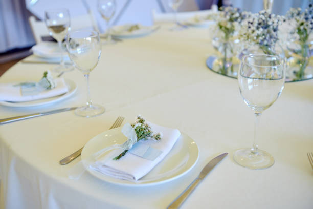 istock Table set with blank guest card, plate with white napkin and cutlery on table, copy space. Place setting at wedding reception. Table served for wedding banquet in restaurant 1297463479