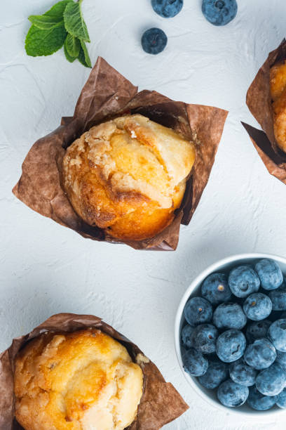istock Blueberry muffins with fresh berries, on white background, top view flat lay 1297463743