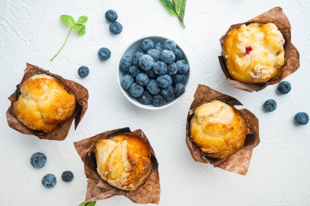 istock Blueberry muffins, on white background, top view flat lay 1297463776