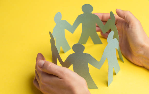 istock Hand Protecting Paper Cut Out Figure 1297464834