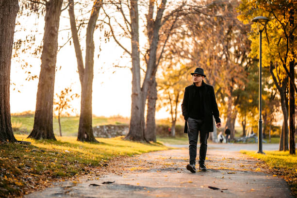 istock Handsome man with hat in autumn park 1297466070