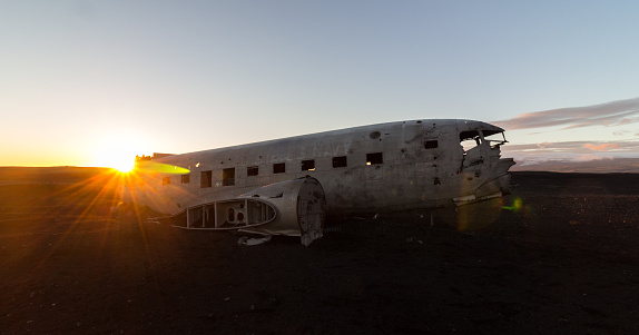 Shot of the Black Sand Beach Plane Wreck with the sunset in the background