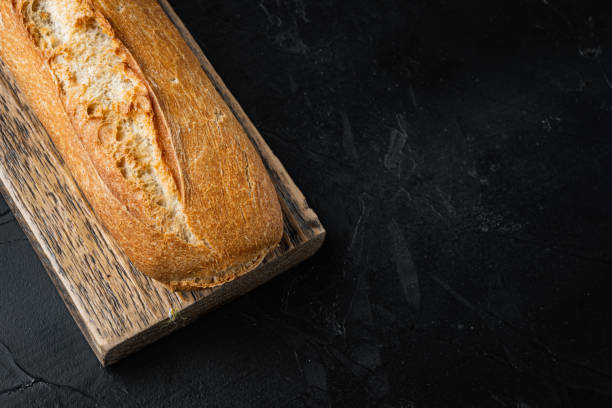 istock Crunchy french baguettes, on black background  with copy space for text 1297467713