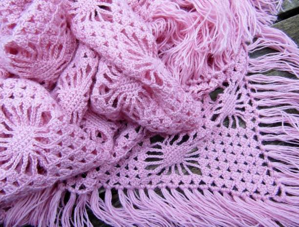 istock Pink tasseled hand knitted shawl wrap 1297467971